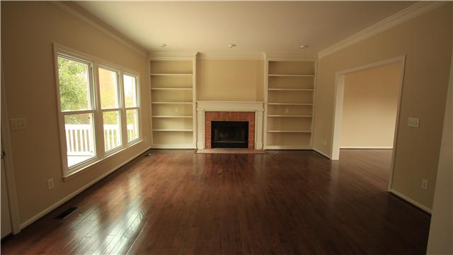 629 Rutherford Lane Franklin, TN 37064 - Photo 8 of 20 Large family room with built in shelving, wood burning fireplace and new hardwood floors.
