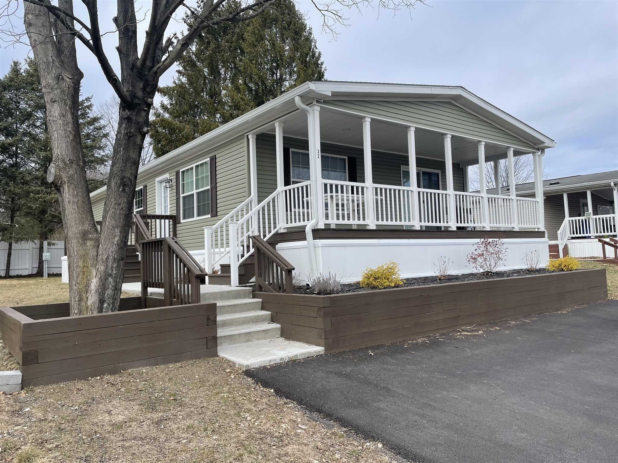 a front view of a house with sitting area
