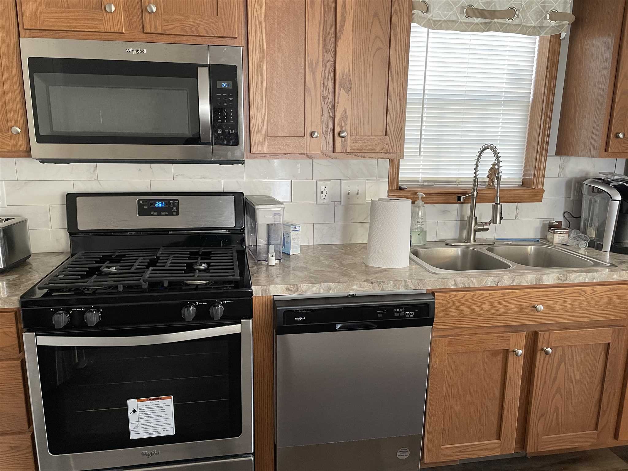 32 Scribo Lane Wappingers Falls, NY 12590 - Photo 6 of 16 a kitchen with granite countertop a stove top oven cabinetry a sink and a window