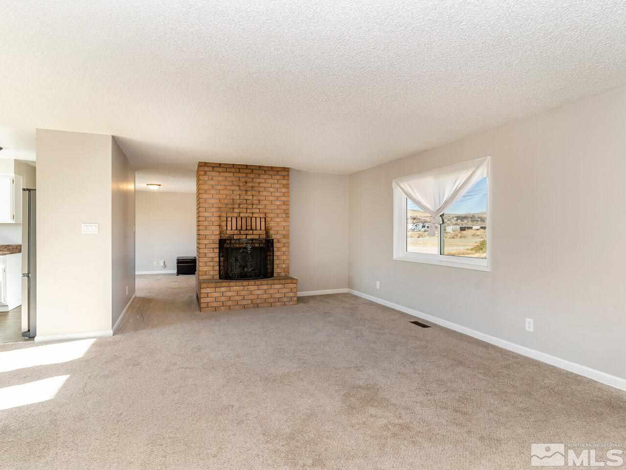 8400 Osage Road Reno, NV 89508 - Photo 10 of 28 an empty room with a window and fireplace