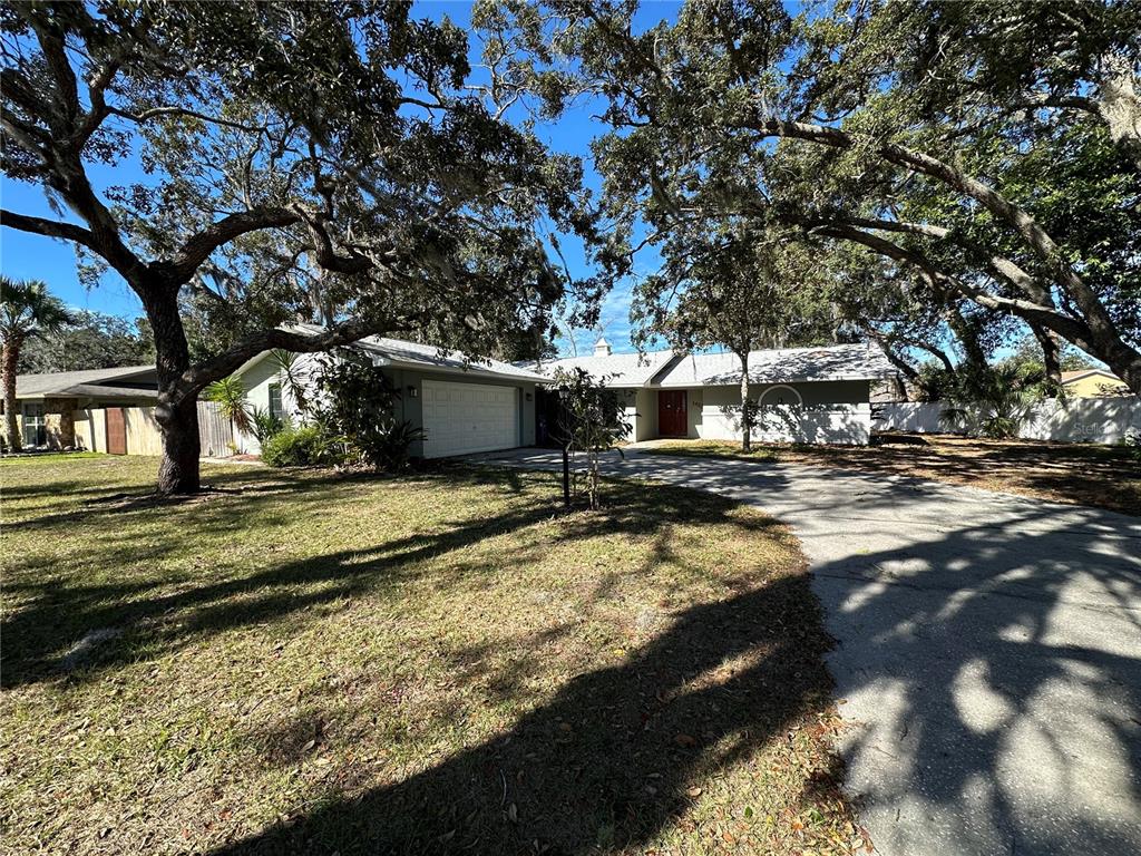 1423 Meadow Lark Road Spring Hill, FL 34606 - Photo 2 of 9 a view of a house with large trees