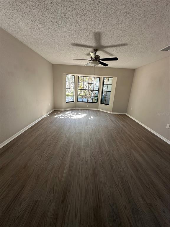 1423 Meadow Lark Road Spring Hill, FL 34606 - Photo 4 of 9 a view of an empty room with wooden floor and a window