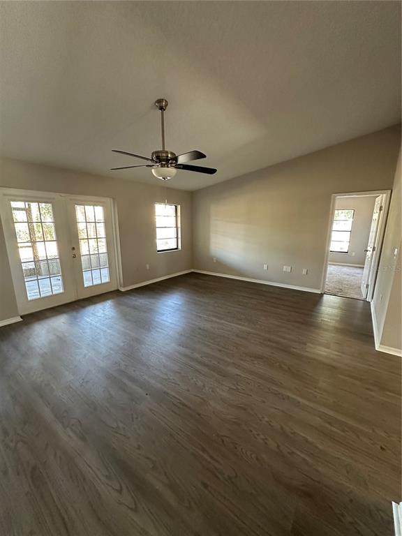 1423 Meadow Lark Road Spring Hill, FL 34606 - Photo 5 of 9 a view of an empty room with window and wooden floor