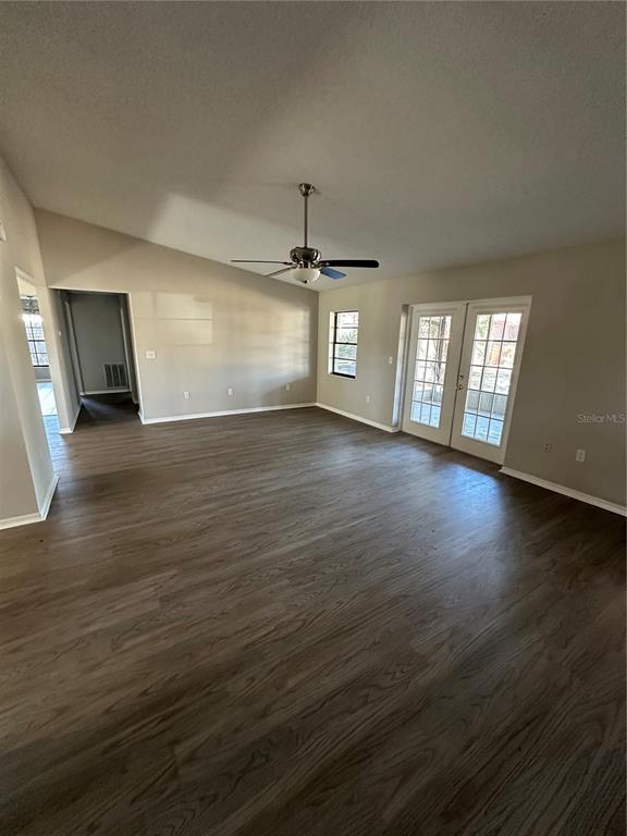 1423 Meadow Lark Road Spring Hill, FL 34606 - Photo 6 of 9 an empty room with wooden floor and windows