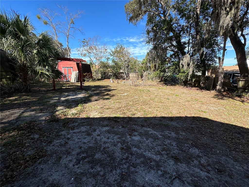 1423 Meadow Lark Road Spring Hill, FL 34606 - Photo 8 of 9 a view of a yard with a house