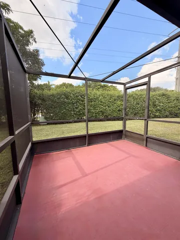 a view of an empty room with a floor to ceiling window