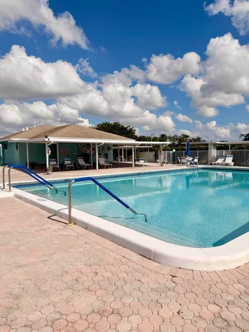 a view of a swimming pool with a yard