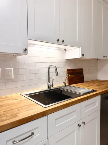 a kitchen with a sink and cabinets