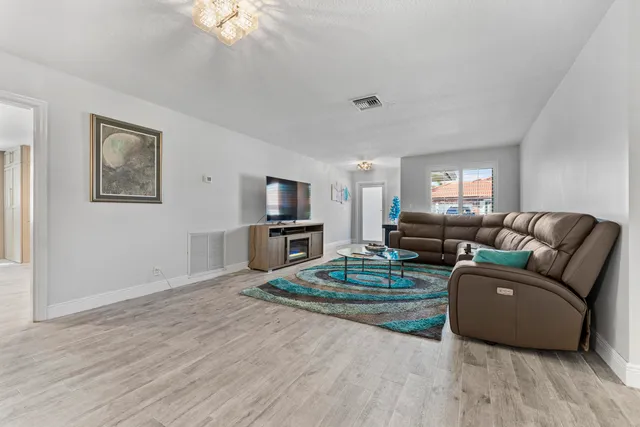 a living room with furniture and a dining table