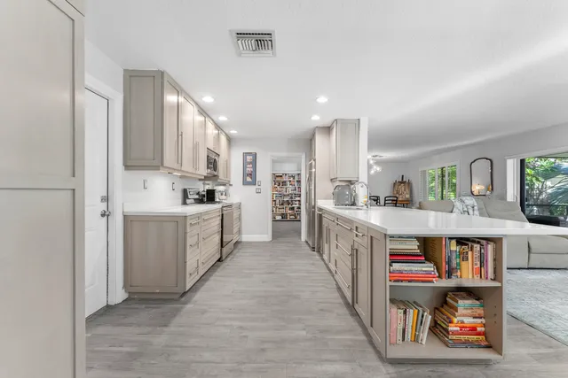 a large kitchen with stainless steel appliances lots of counter top space