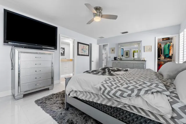 a spacious bedroom with a bed and a chandelier
