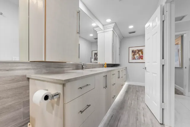 a spacious bedroom with a bed a couch and a window