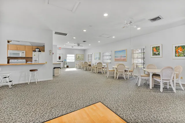 a room with pool table and windows