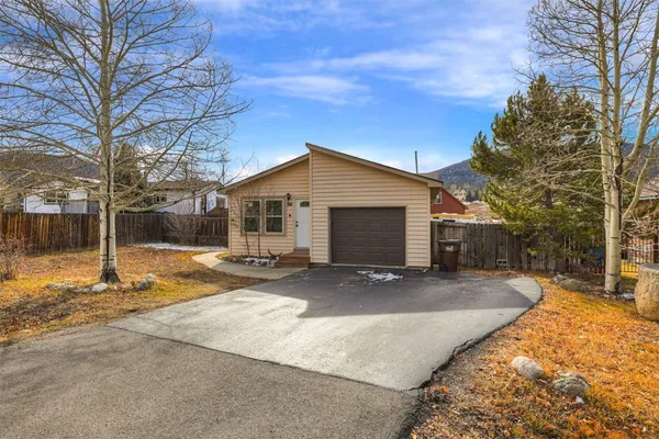 a view of a house with a yard covered in snow