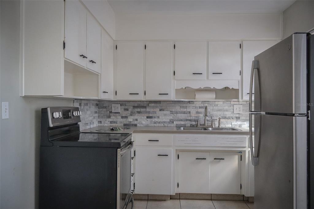 2708 Dixie Road Lakeland, FL 33801 - Photo 8 of 31 a kitchen with cabinets appliances a sink and a counter top