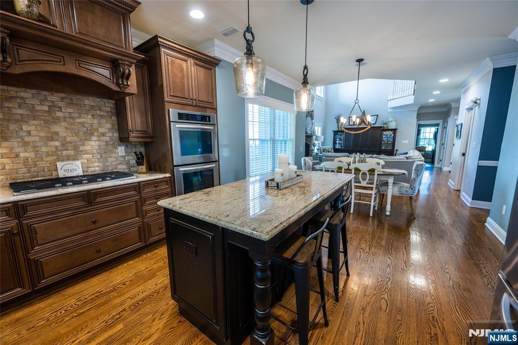 44 Forest Terrace Wayne, NJ 07470 - Photo 13 of 32 a kitchen with a table chairs refrigerator and cabinets