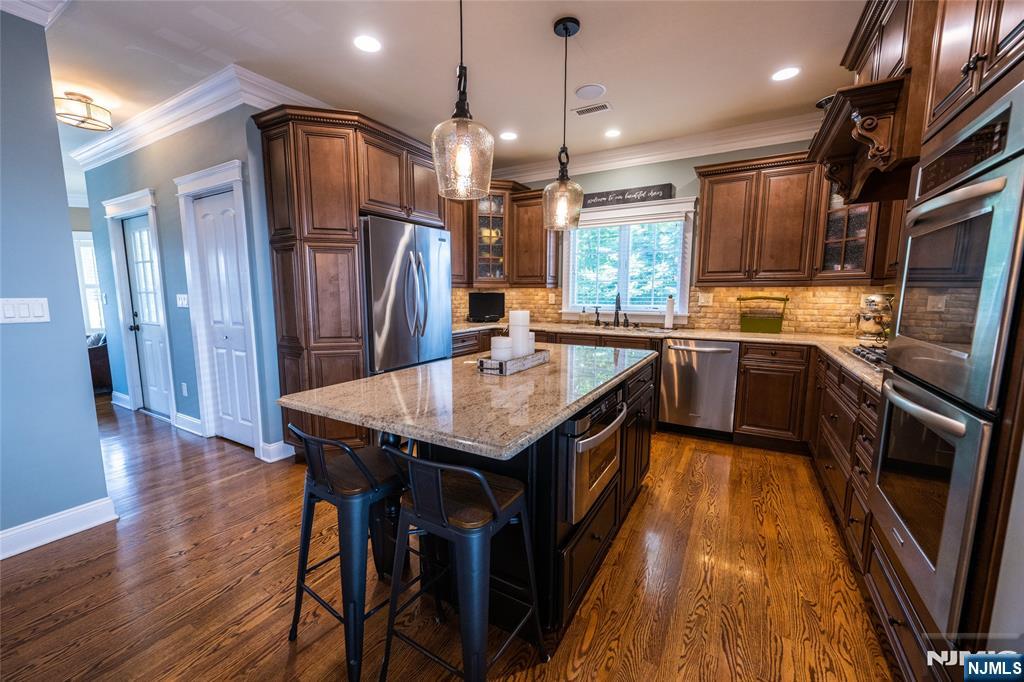 44 Forest Terrace Wayne, NJ 07470 - Photo 15 of 32 a kitchen with stainless steel appliances granite countertop a sink a stove and a refrigerator