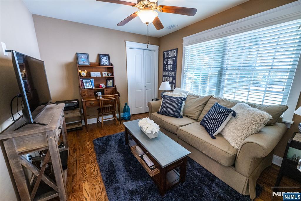 44 Forest Terrace Wayne, NJ 07470 - Photo 27 of 32 a living room with furniture a flat screen tv and a large window