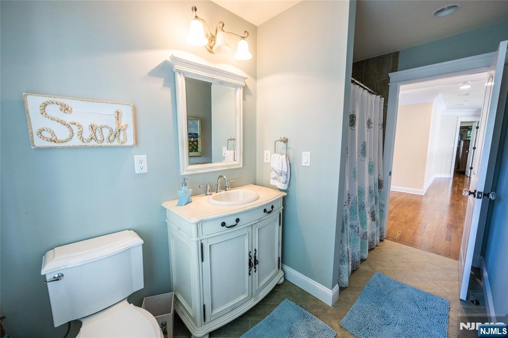 44 Forest Terrace Wayne, NJ 07470 - Photo 28 of 32 a bathroom with a toilet sink and mirror