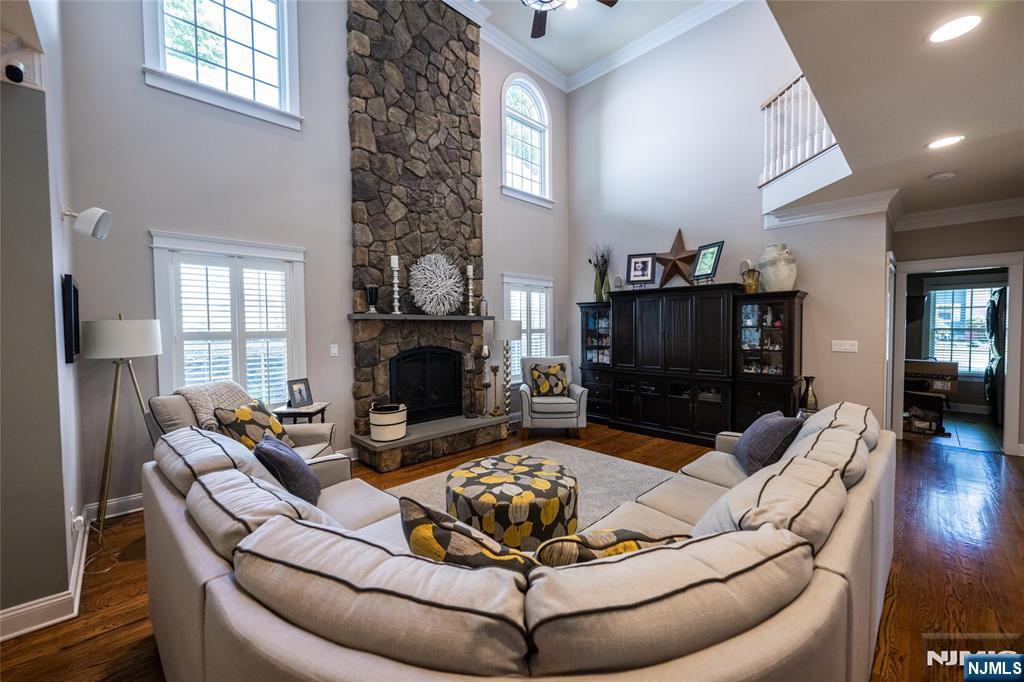 44 Forest Terrace Wayne, NJ 07470 - Photo 10 of 32 a living room with furniture a large window and a fireplace