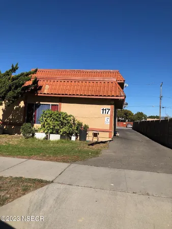 a view of a car park in front of a house