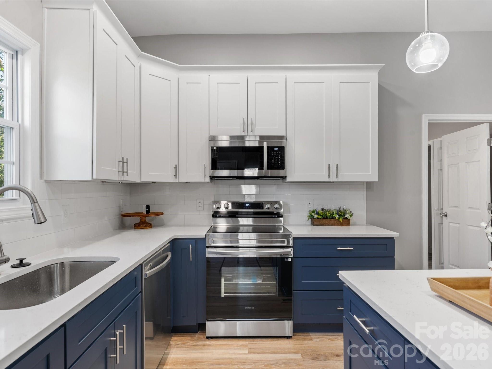 105 South York Street Lancaster, SC 29720 - Photo 11 of 28 a kitchen with stainless steel appliances granite countertop a stove a sink and a microwave