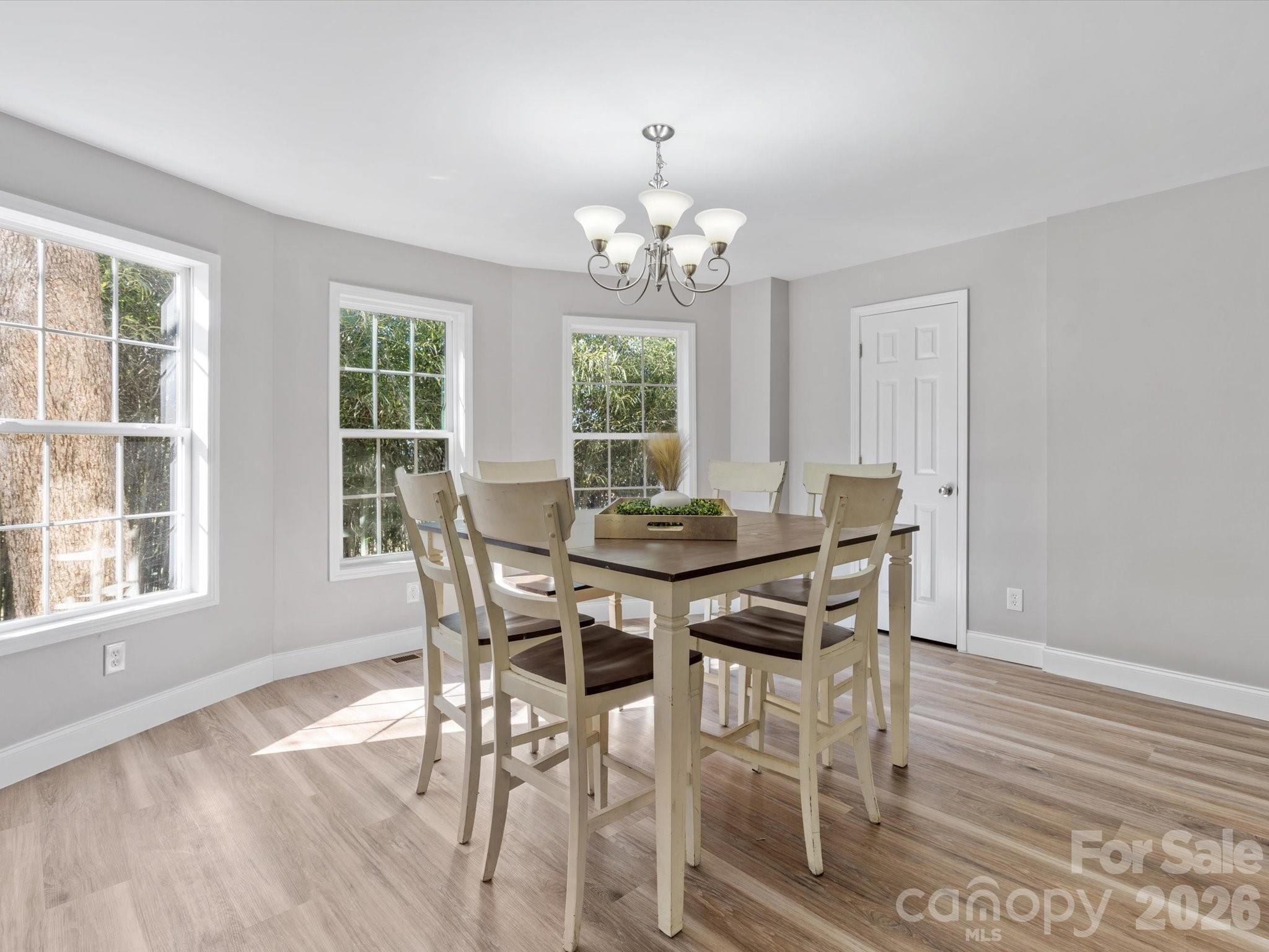 105 South York Street Lancaster, SC 29720 - Photo 14 of 28 a view of a dining room with furniture a chandelier and wooden floor