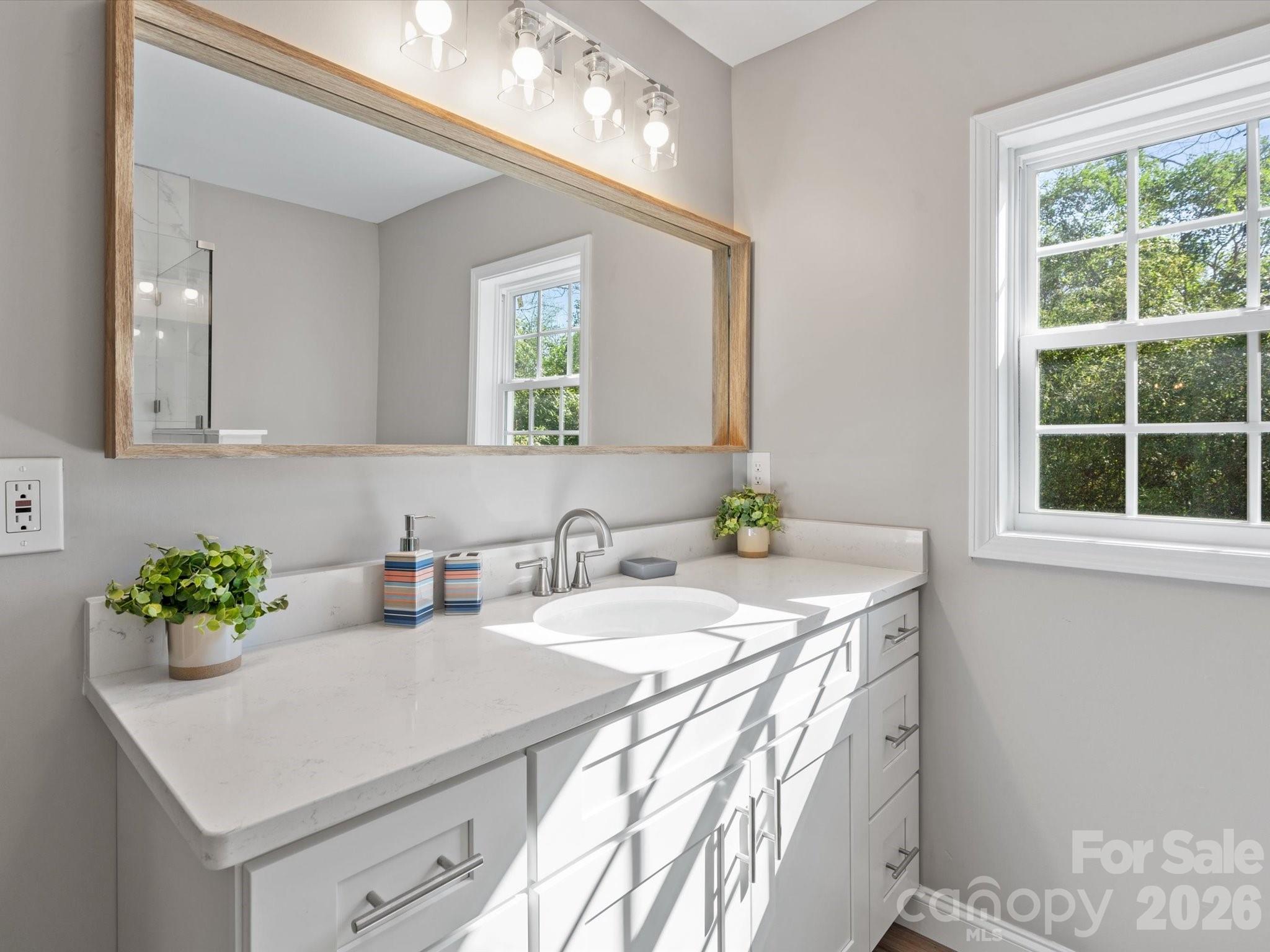 105 South York Street Lancaster, SC 29720 - Photo 21 of 28 a bathroom with a sink a vanity and a mirror