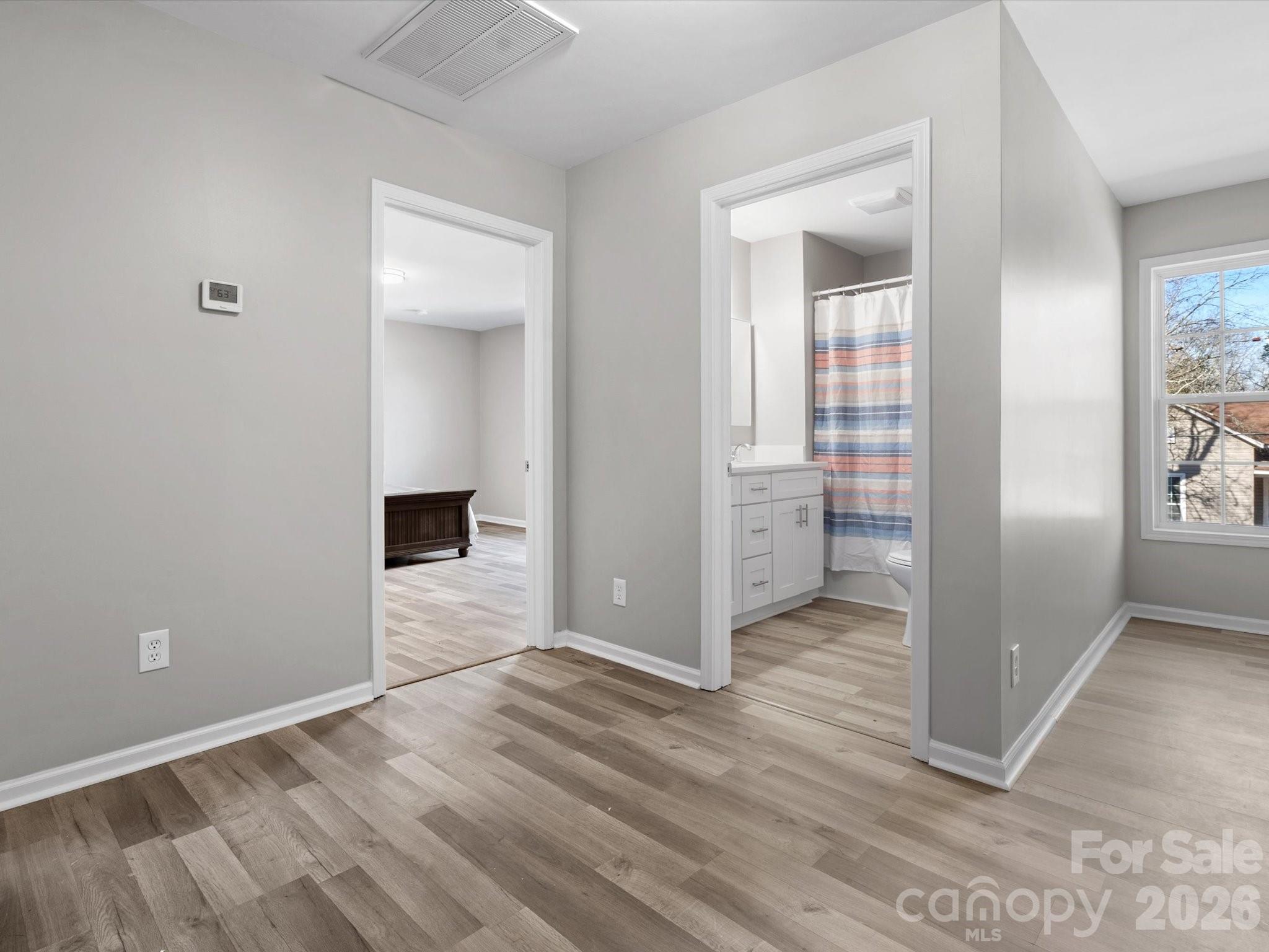 105 South York Street Lancaster, SC 29720 - Photo 23 of 28 an empty room with wooden floor and windows
