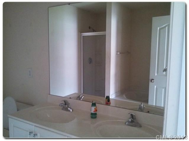 2216 Gooseberry Road Charlotte, NC 28208 - Photo 12 of 12 a bathroom with a sink and a mirror