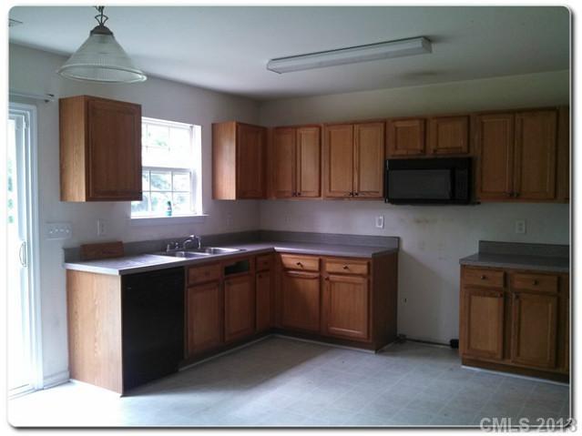 2216 Gooseberry Road Charlotte, NC 28208 - Photo 6 of 12 a kitchen with stainless steel appliances granite countertop a sink and a stove