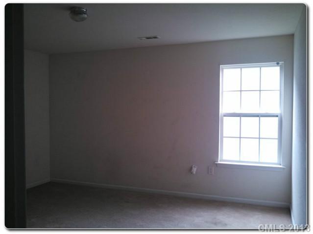 2216 Gooseberry Road Charlotte, NC 28208 - Photo 7 of 12 an empty room with a window