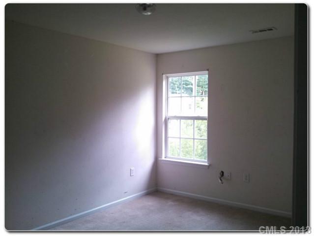 2216 Gooseberry Road Charlotte, NC 28208 - Photo 8 of 12 a view of an empty room with a window