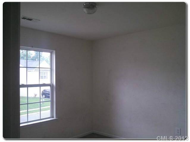2216 Gooseberry Road Charlotte, NC 28208 - Photo 9 of 12 a view of an empty room with a window