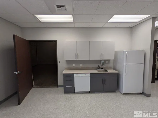 a kitchen with stainless steel appliances a refrigerator and a sink
