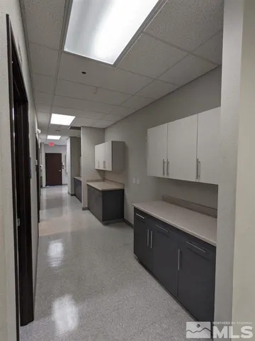 a view of a kitchen with a sink and cabinets