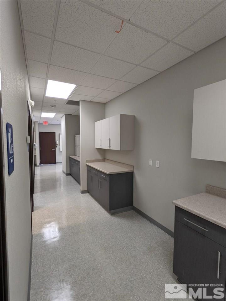 3745 North Carson Street, Unit 3745 Carson City, NV 89706 - Photo 15 of 33 a large white kitchen with a sink and dishwasher a stove top oven with wooden floor