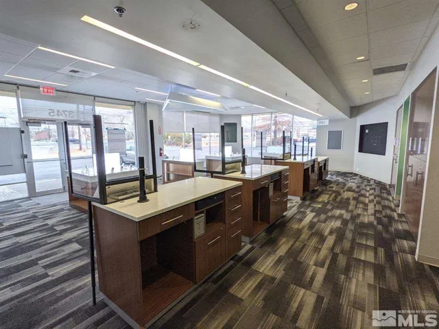 a large kitchen with stainless steel appliances granite countertop a stove and a wooden floors