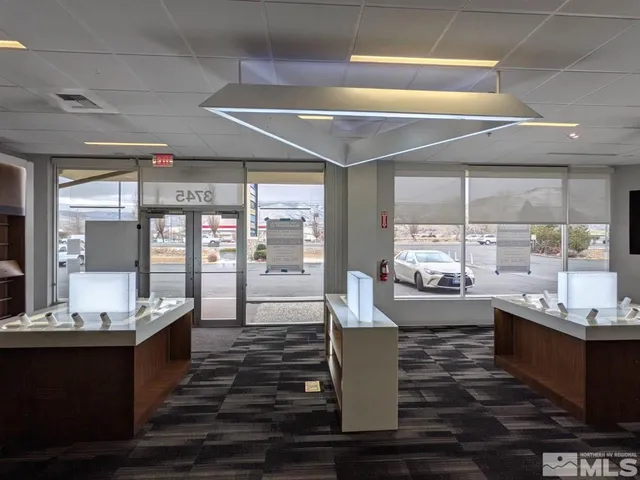 a large white kitchen with a large window