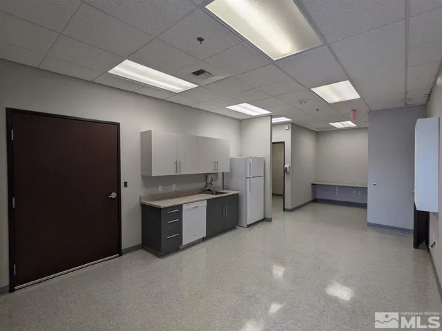 a large kitchen with kitchen island a sink stainless steel appliances and cabinets