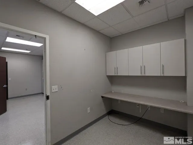 a bathroom with a double vanity sink and a toilet