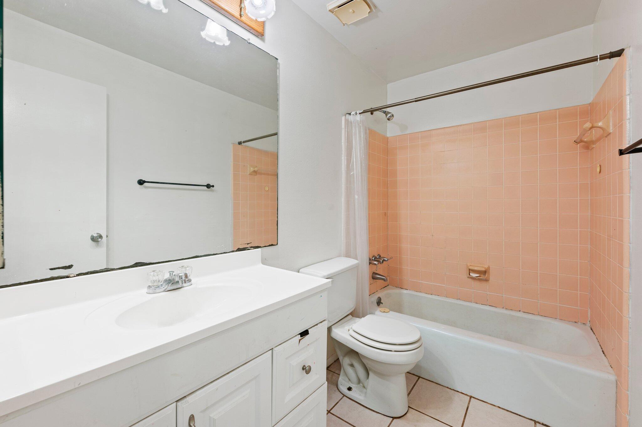 822 Onyx Drive Northeast Palm Bay, FL 32905 - Photo 11 of 21 a bathroom with a sink a toilet and shower