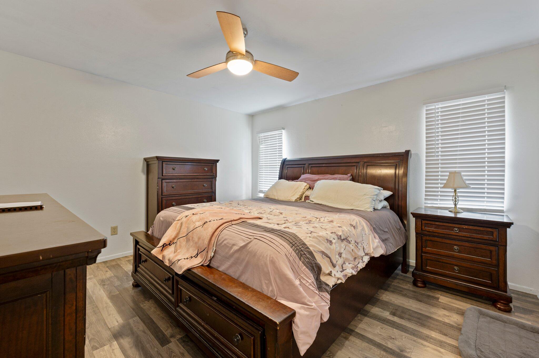 822 Onyx Drive Northeast Palm Bay, FL 32905 - Photo 13 of 21 a bedroom with a bed and a chandelier
