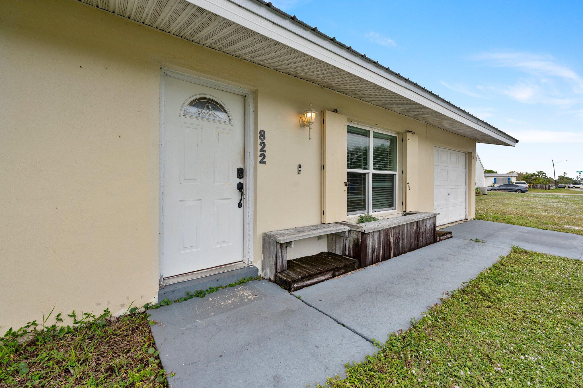 822 Onyx Drive Northeast Palm Bay, FL 32905 - Photo 19 of 21 a front view of a house with garden