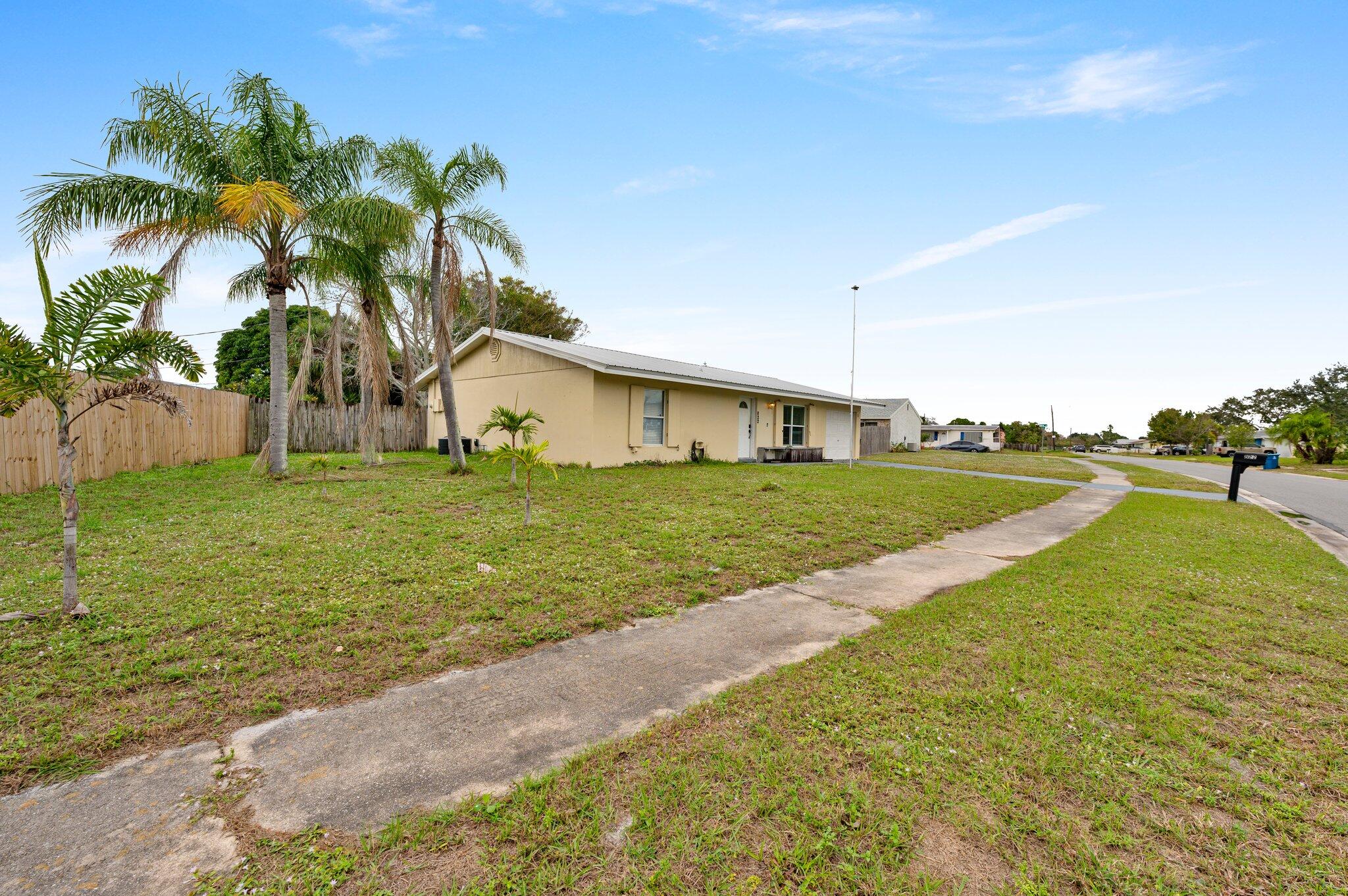 822 Onyx Drive Northeast Palm Bay, FL 32905 - Photo 21 of 21 a view of a house with a yard
