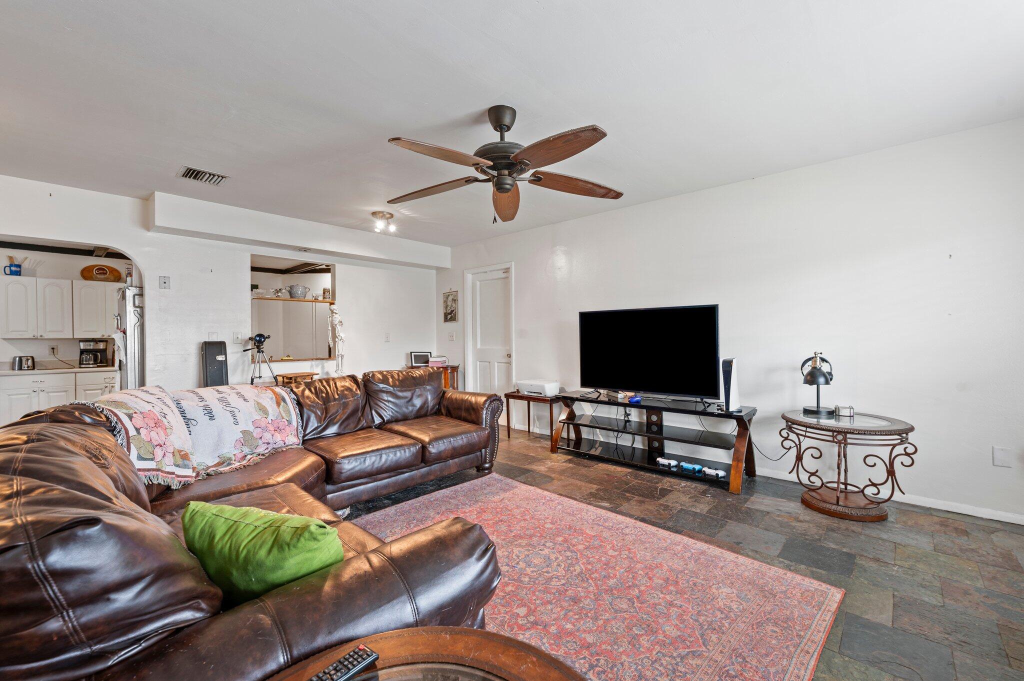 822 Onyx Drive Northeast Palm Bay, FL 32905 - Photo 4 of 21 a living room with furniture and a flat screen tv