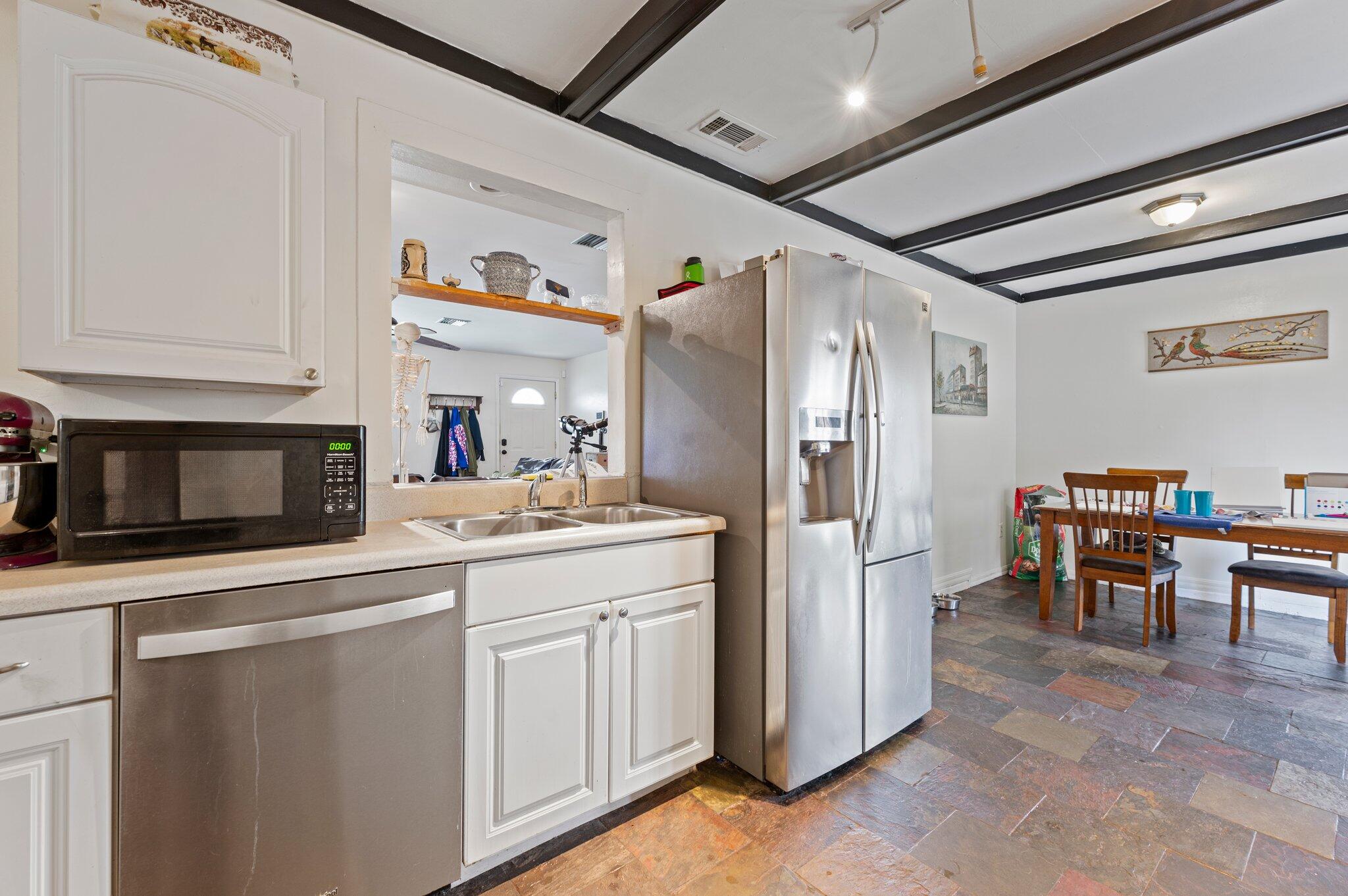 822 Onyx Drive Northeast Palm Bay, FL 32905 - Photo 7 of 21 a kitchen with refrigerator and cabinets