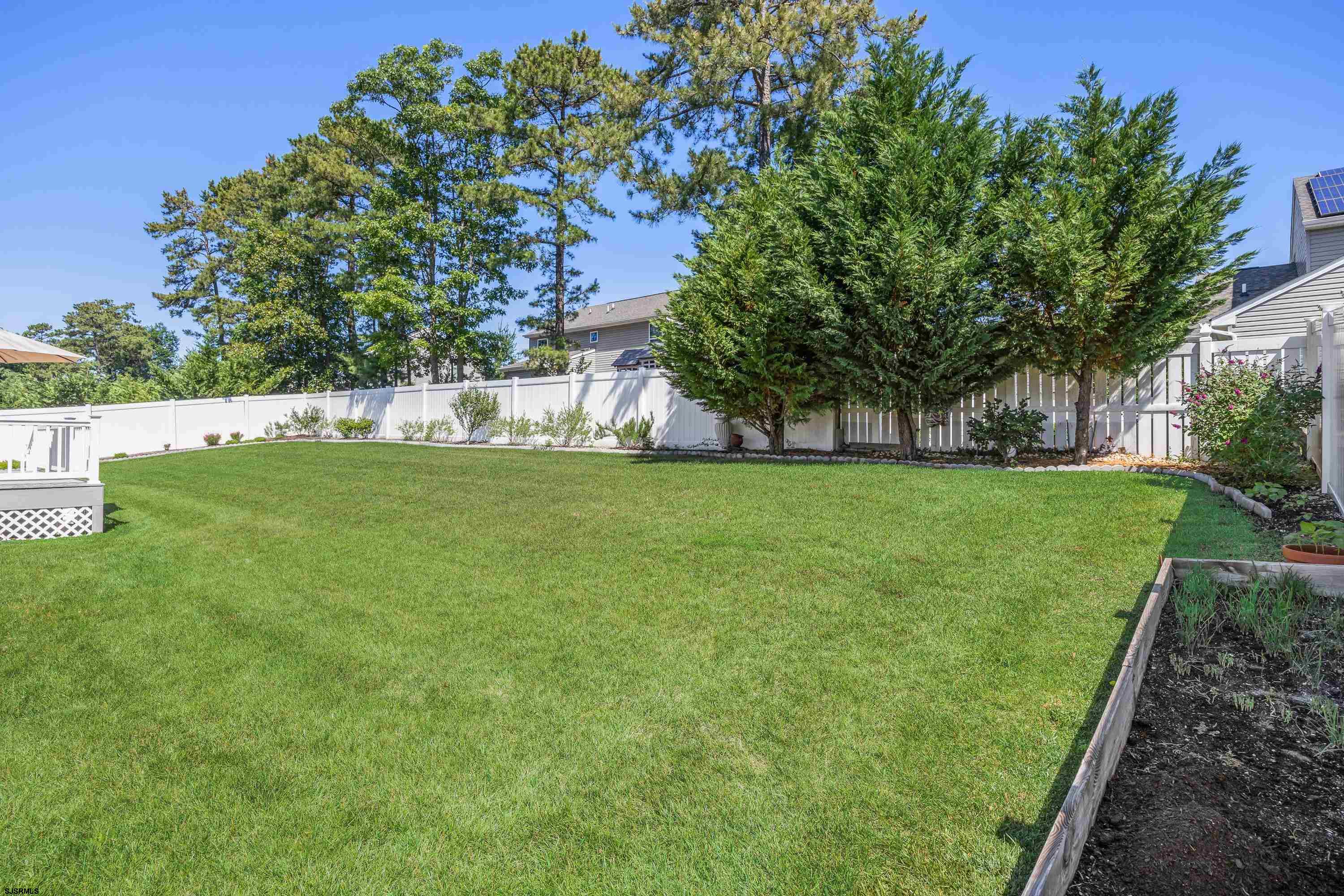 215 Surf Road Egg Harbor Township, NJ 08234 - Photo 26 of 31 a view of a grassy field with trees