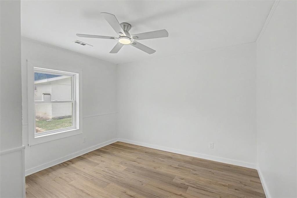 2115 King Road Dalton, GA 30720 - Photo 28 of 54 an empty room with wooden floor fan and windows