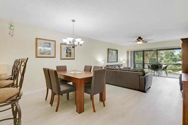 a view of a dining room with furniture and chandelier